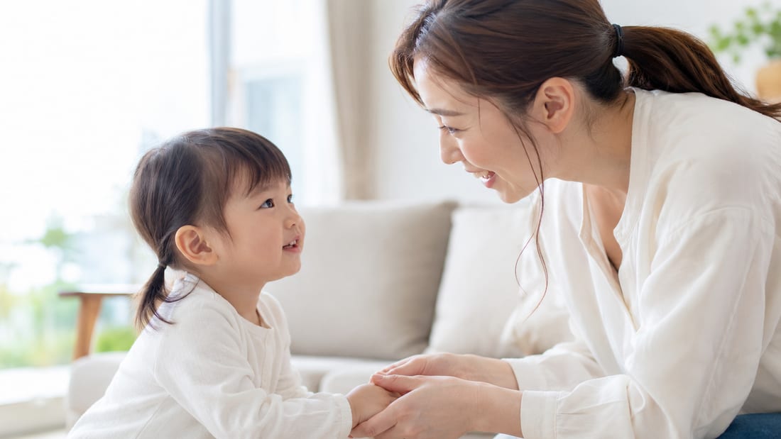 手をつないで話しかける親子